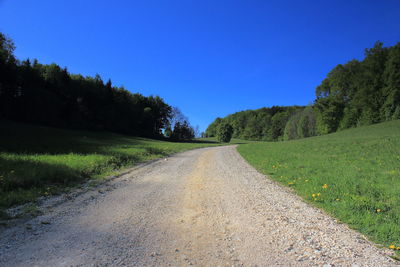 Empty road along countryside landscape