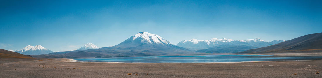 Scenic view of mountains against blue sky