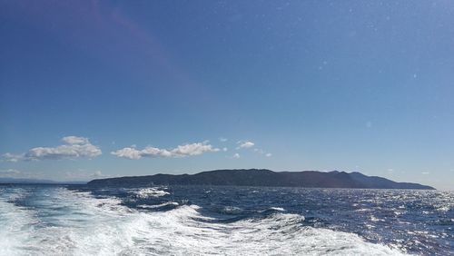 Scenic view of sea against clear blue sky
