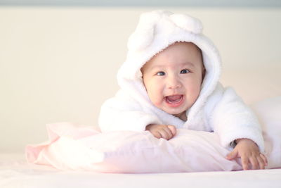 Portrait of cute baby boy sleeping on bed at home
