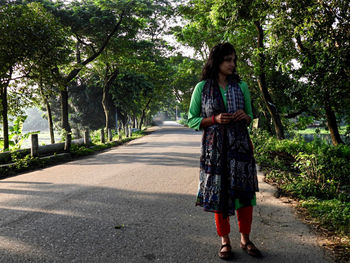 Full length of a woman walking on road