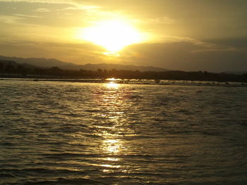 Scenic view of sea and mountains during sunset