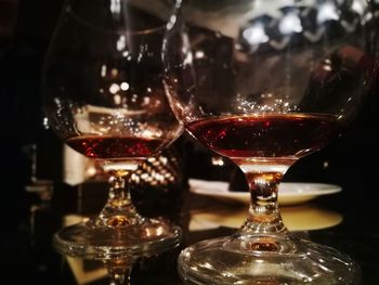 Close-up of wine glasses on table