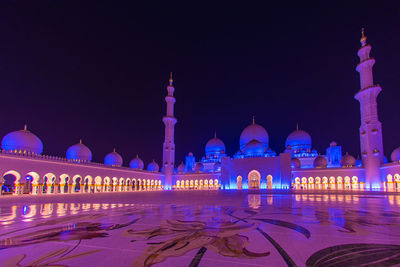Low angle view of mosque against sky at night