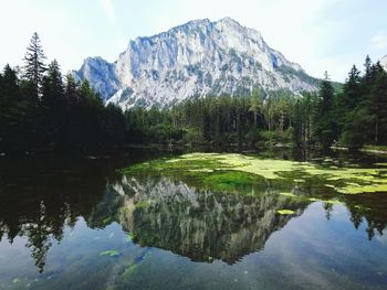 Scenic view of lake and mountains against sky