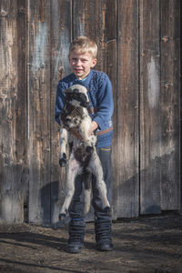 Full length portrait of boy with dog