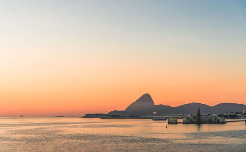 Scenic view of sea against clear sky during sunset