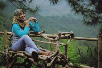 Full length of woman sitting on land