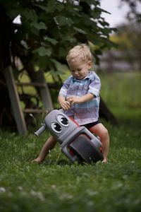 Full length of boy playing with toy on field