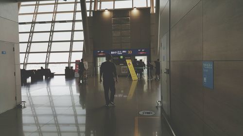 Rear view of man standing in airport