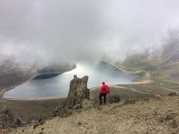 Rear view of man standing on mountain