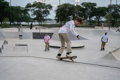 Rear view of man skateboarding on skateboard