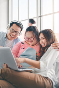 Cheerful family looking at digital tablet at home