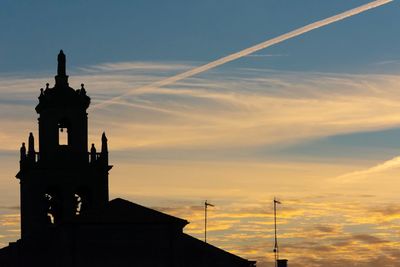 Silhouette building against sky during sunset