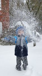 Full length of woman standing on snow