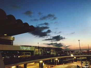 Low angle view of illuminated bridge against sky at sunset