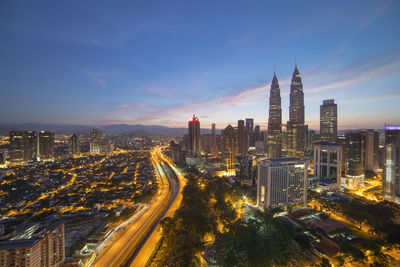 High angle view of city lit up at night