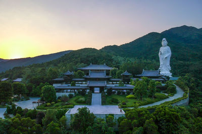 Statue on mountain against clear sky