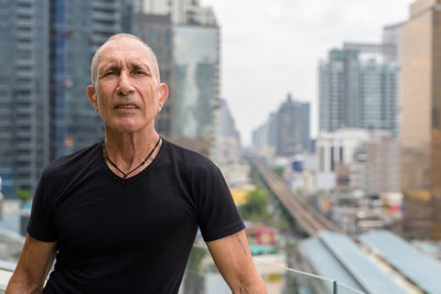 Portrait of man with city in background