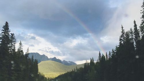 Scenic view of mountains against cloudy sky