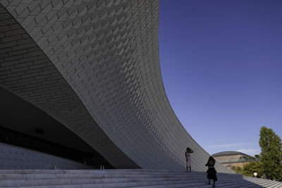 Low angle view of modern building against blue sky