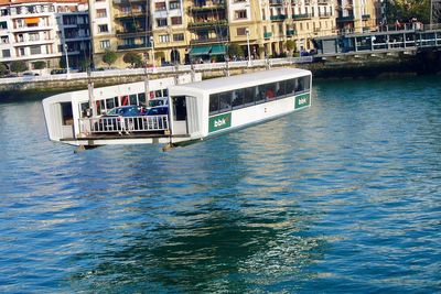 Boat in river against buildings