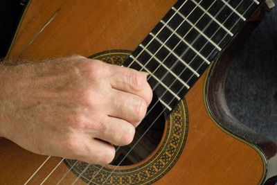 Close-up of man playing guitar