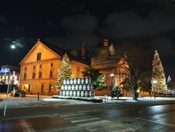 Illuminated buildings in city at night during winter