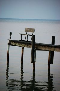 Lifeguard hut in lake against sky