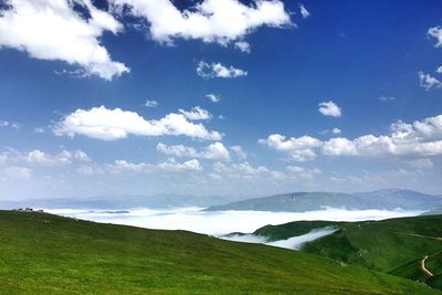 Scenic view of landscape against cloudy sky