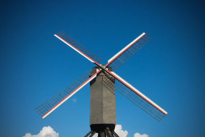 Low angle view of traditional flemish windmill against clear blue sky