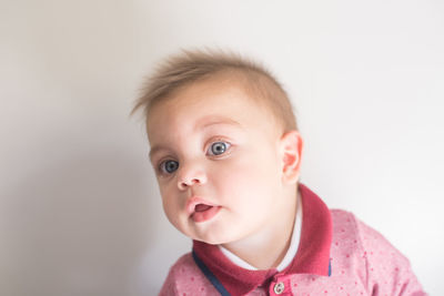 Portrait of cute baby against white background