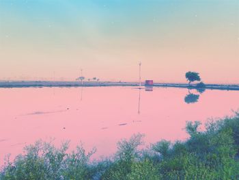 Scenic view of lake against sky during sunset