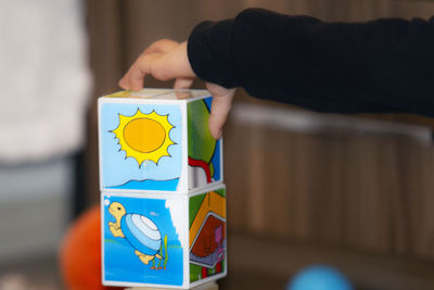 Midsection of person holding multi colored painting