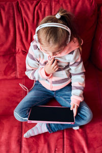 Full length of girl using mobile phone