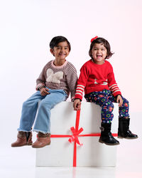 Portrait of smiling couple standing against white background