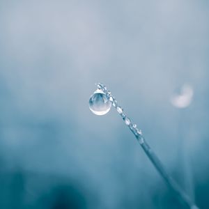 Close-up of water drop against sky