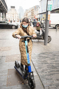 Brussels belgium - 01.31.2022 a young woman in a warm down jacket and a mask