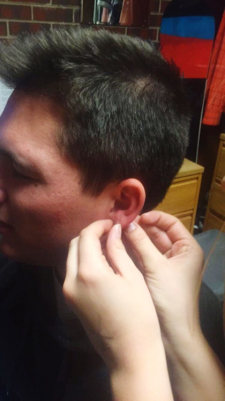 person, indoors, lifestyles, holding, part of, headshot, close-up, leisure activity, cropped, human finger, bonding, care, focus on foreground, animal themes, cute, childhood