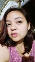 Close-up portrait of smiling young woman