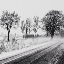 Road passing through snow covered landscape