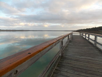 Pier over sea against sky during sunset