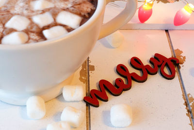 Close-up of marshmallows by text on table