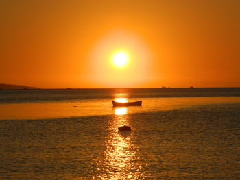 Scenic view of sea against orange sky