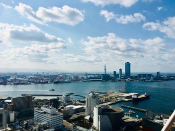 Aerial view of sea and buildings against sky