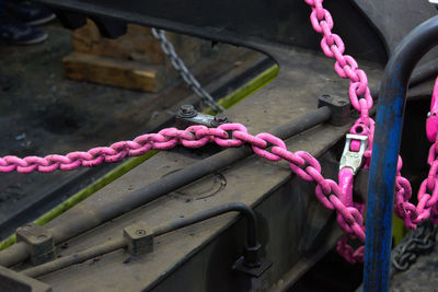 Close-up of rope tied on metal chain