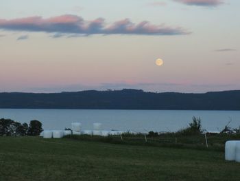 Scenic view of lake against sky at sunset