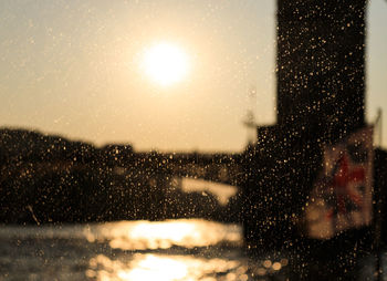 City seen through wet glass window during rainy season