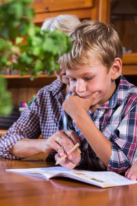 Boy using digital tablet while sitting at home