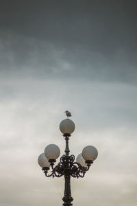 Low angle view of street light against sky